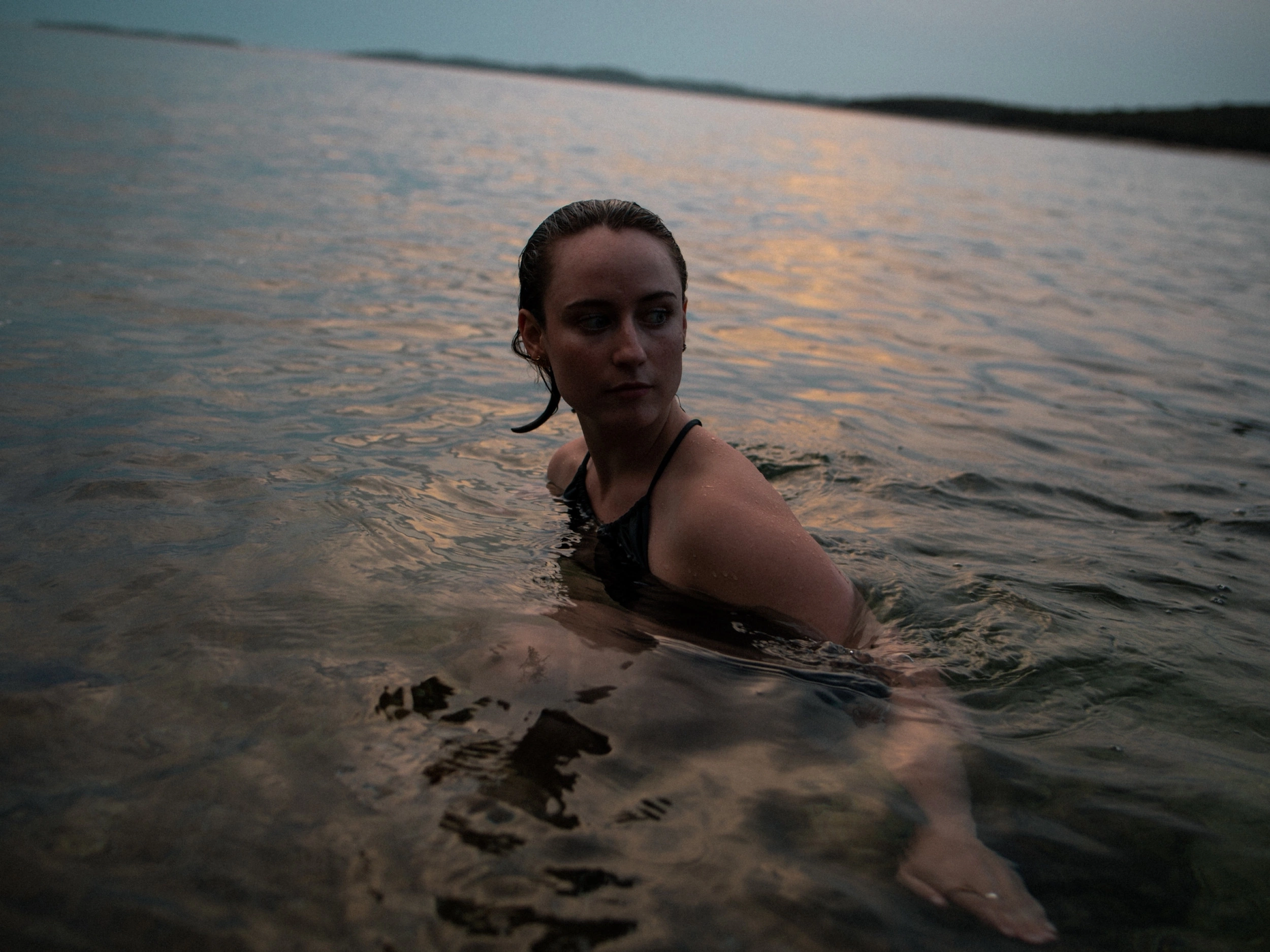 woman swimming in the sea in sundown
