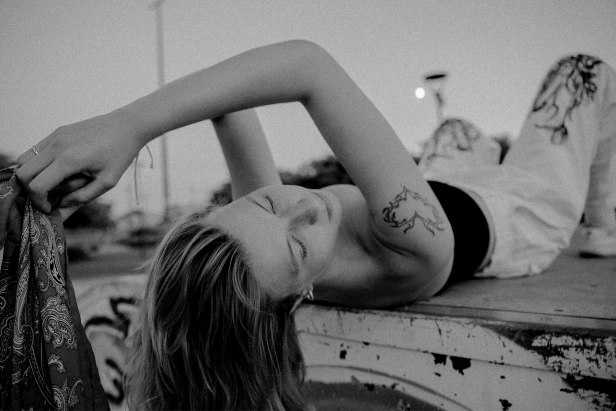 young woman lying on a halfpipe on a skate park